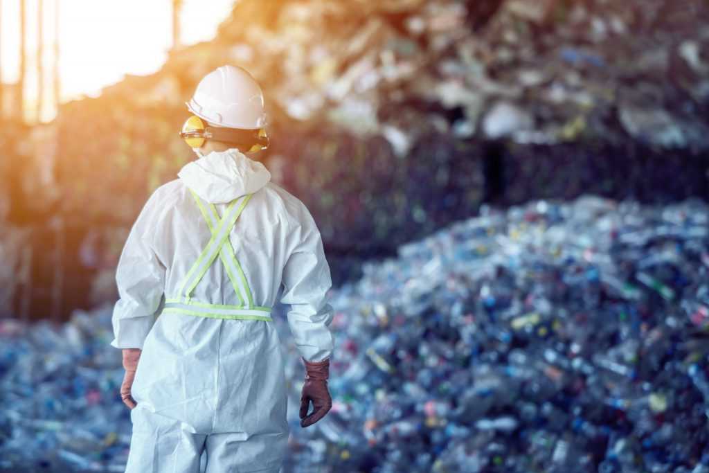 Waste processing plant. Technological process plastic bottles at the factory for processing and recycling. The worker recycling factory,engineers is.